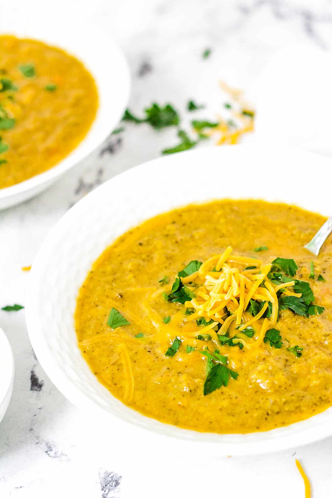 easy healthy instant pot broccoli cheddar soup recipe in a white bowl