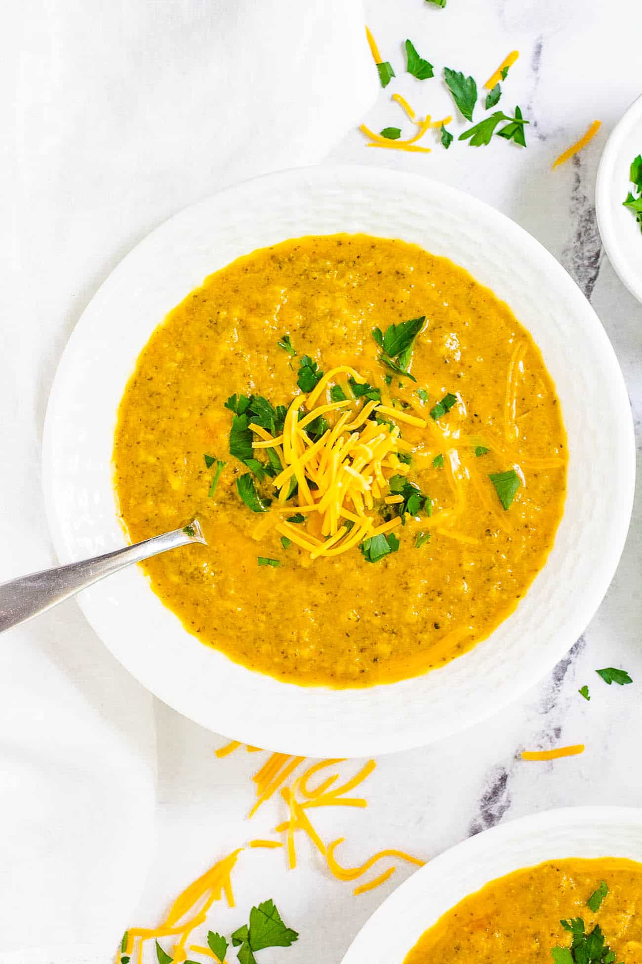 Easy, healthy Instant Pot Broccoli Cheddar Soup recipe in a white bowl