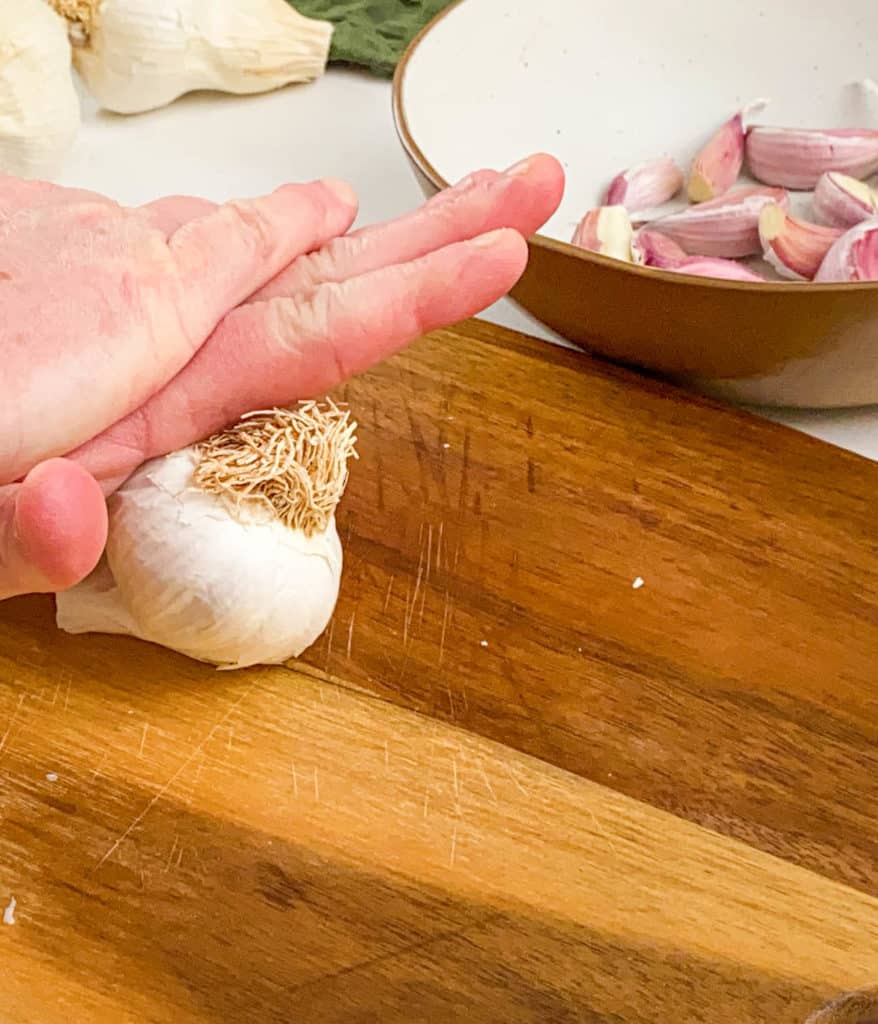 pressing garlic with hands