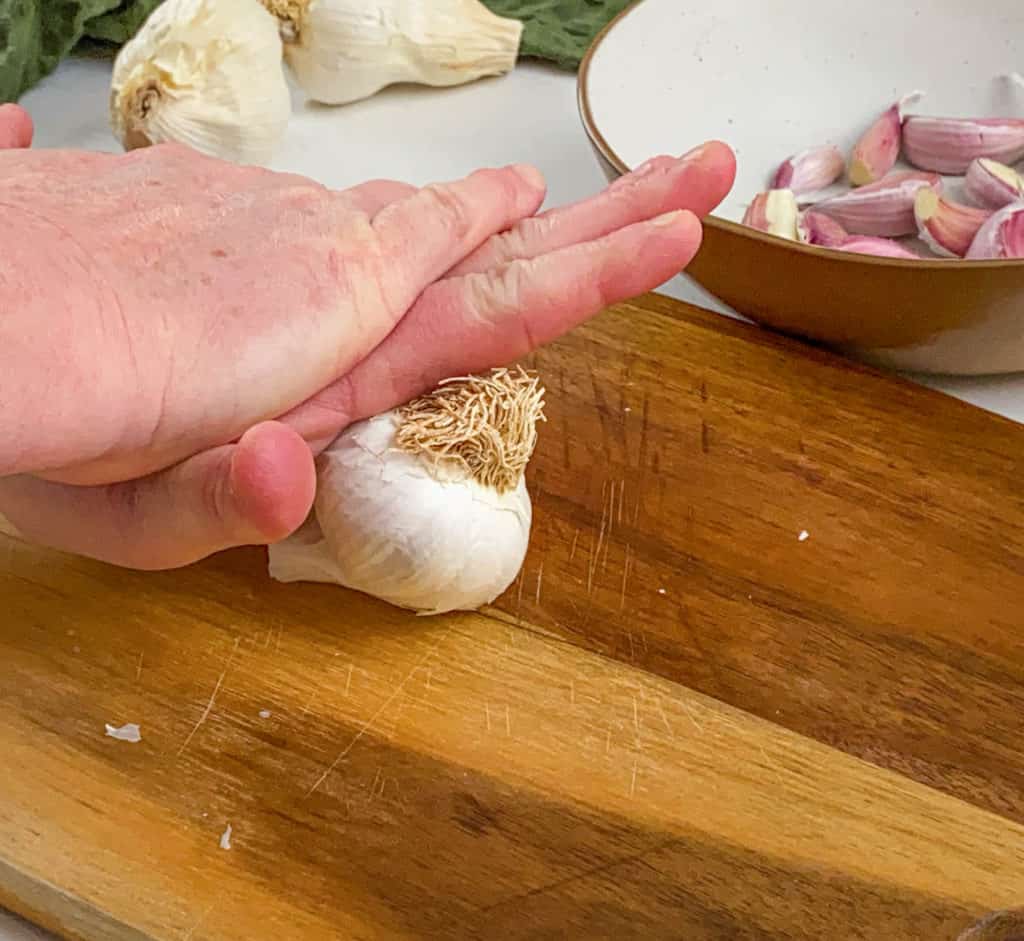 pressing garlic with hands