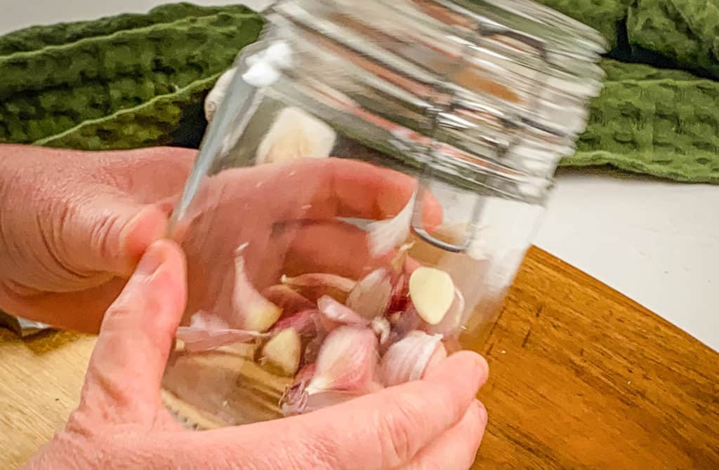 how to peel garlic - garlic peeling hack by shaking jar with cloves in it