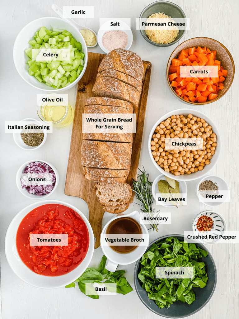 All of the ingredients for Italian chickpea soup on a white background. 