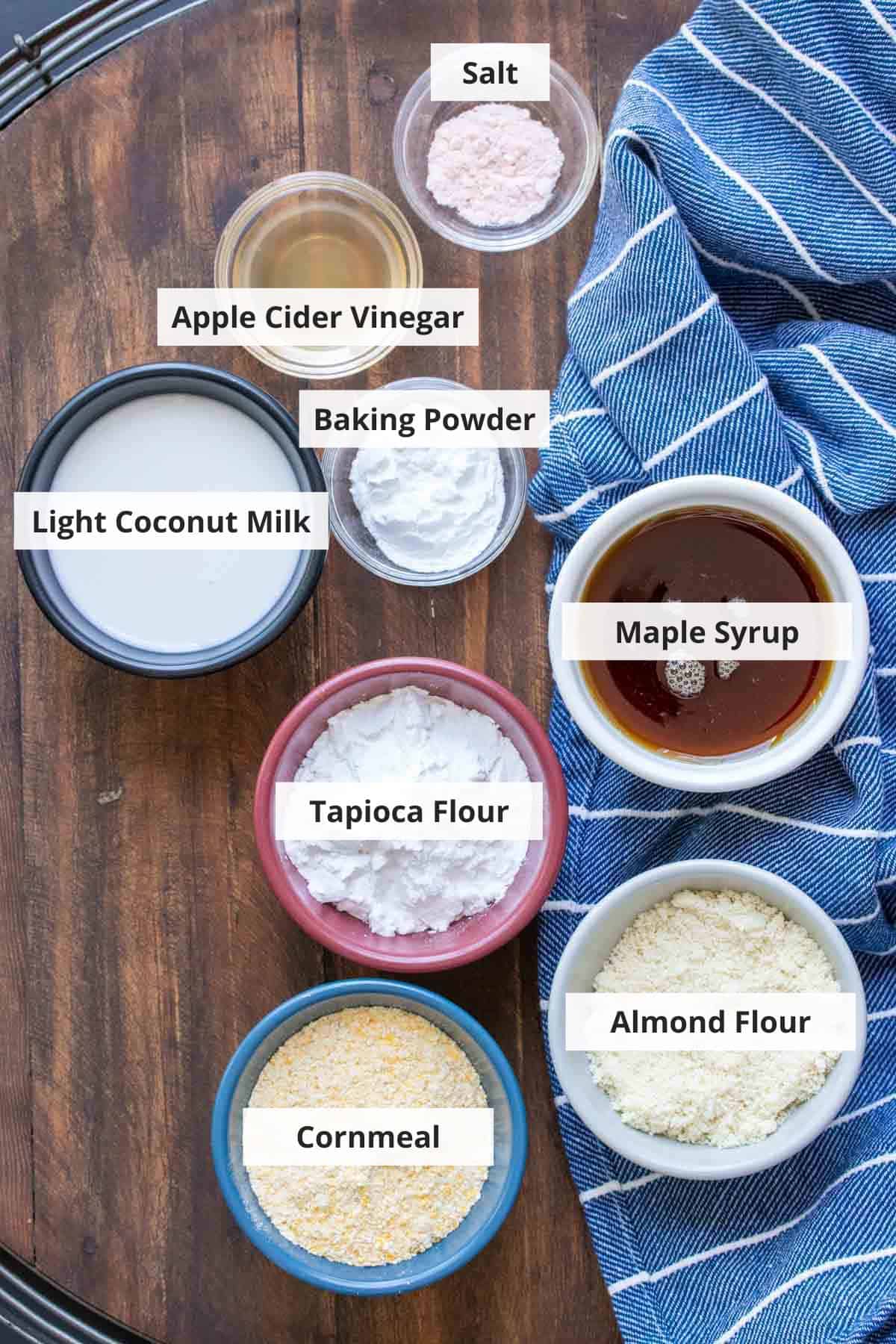 Ingredients for gluten free vegan cornbread muffins recipe on a wood background.