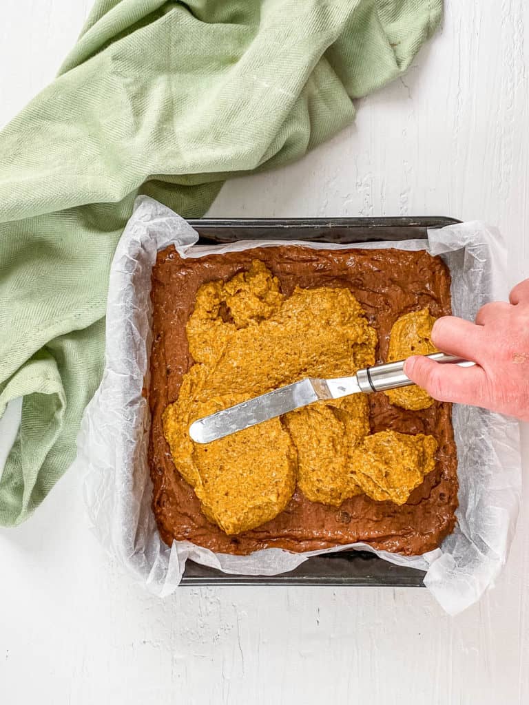 pumpkin batter spread on top of chocolate batter