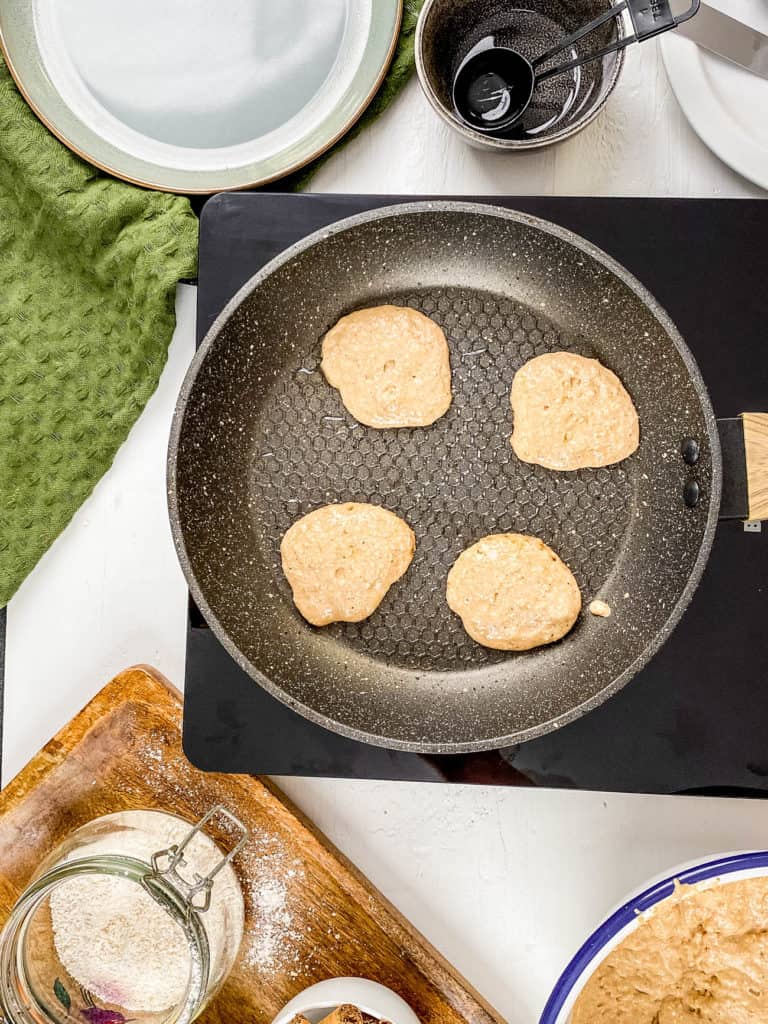 whole grain mini pancakes - silver dollar pancakes on a skillet
