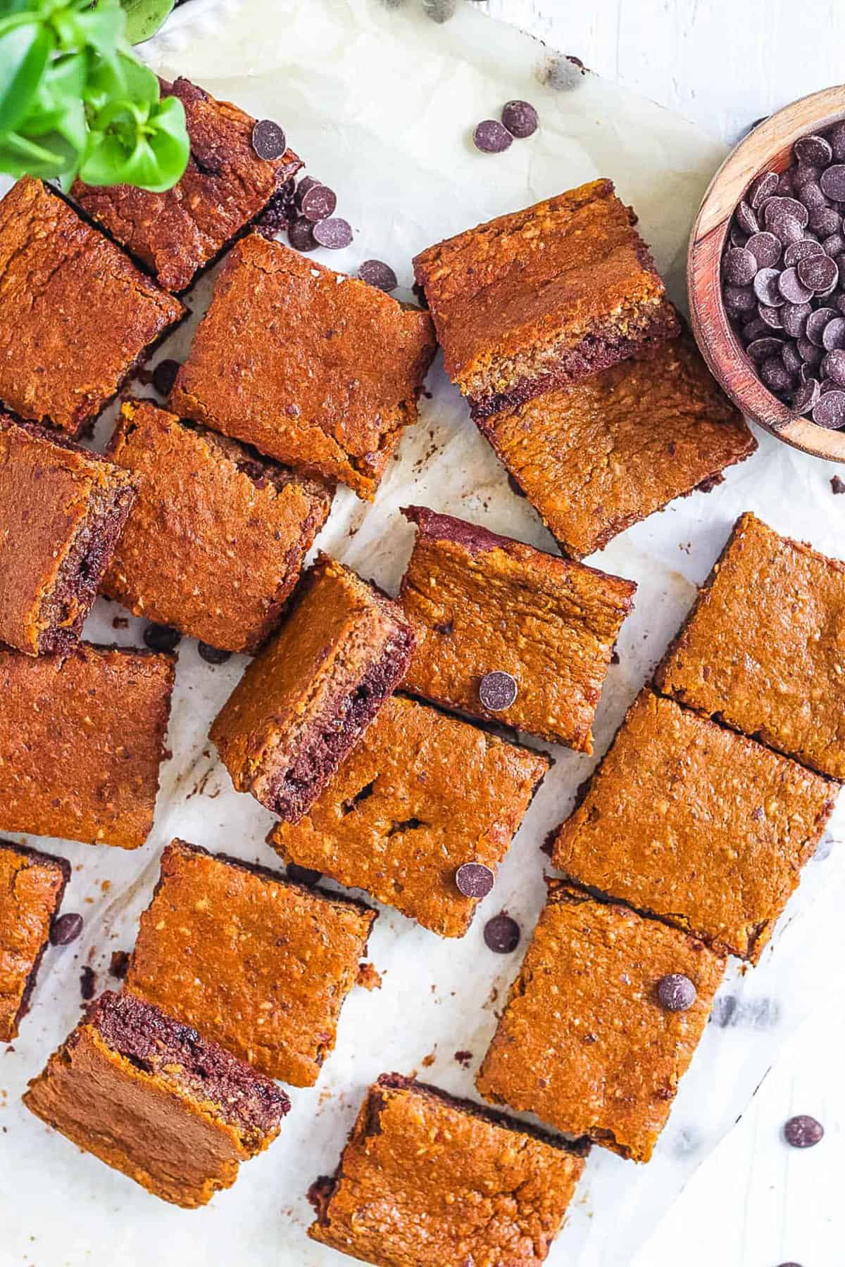 Low calorie, healthy pumpkin brownies on parchment paper.