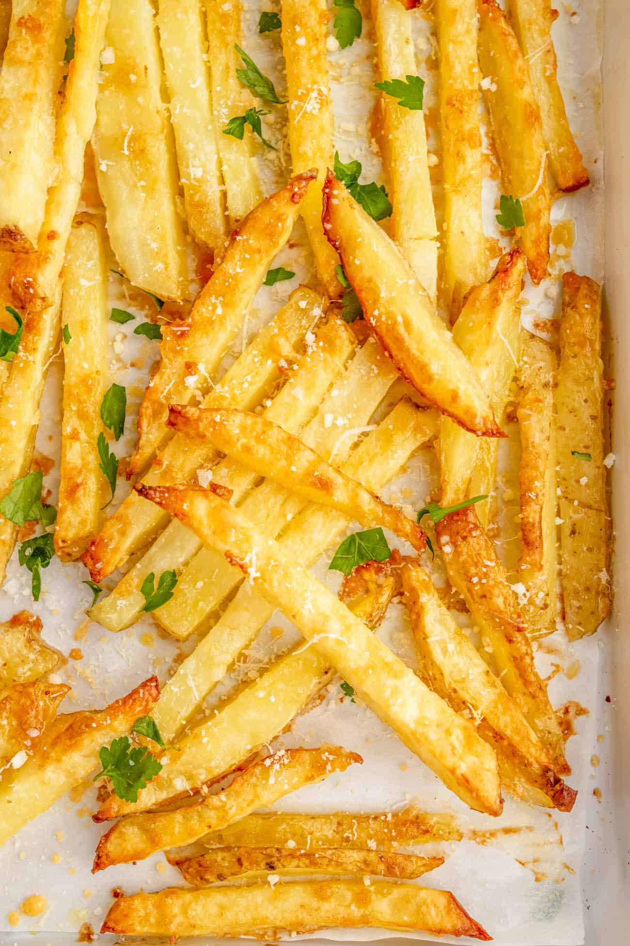 closeup of easy homemade baked parmesan truffle fries recipe with garlic