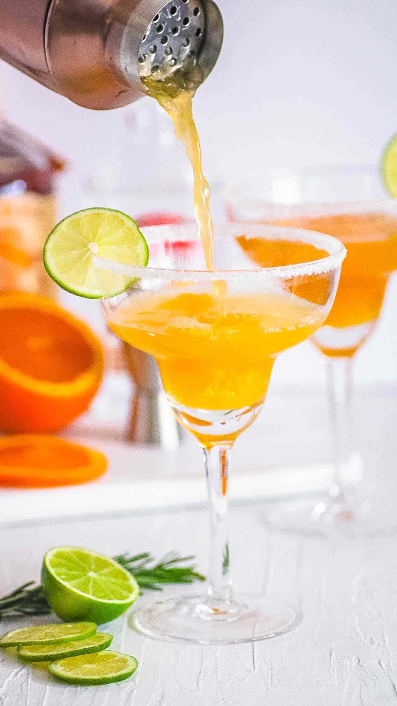 easy italian margarita recipe with amaretto and orange juice - cocktail served in a margarita glass