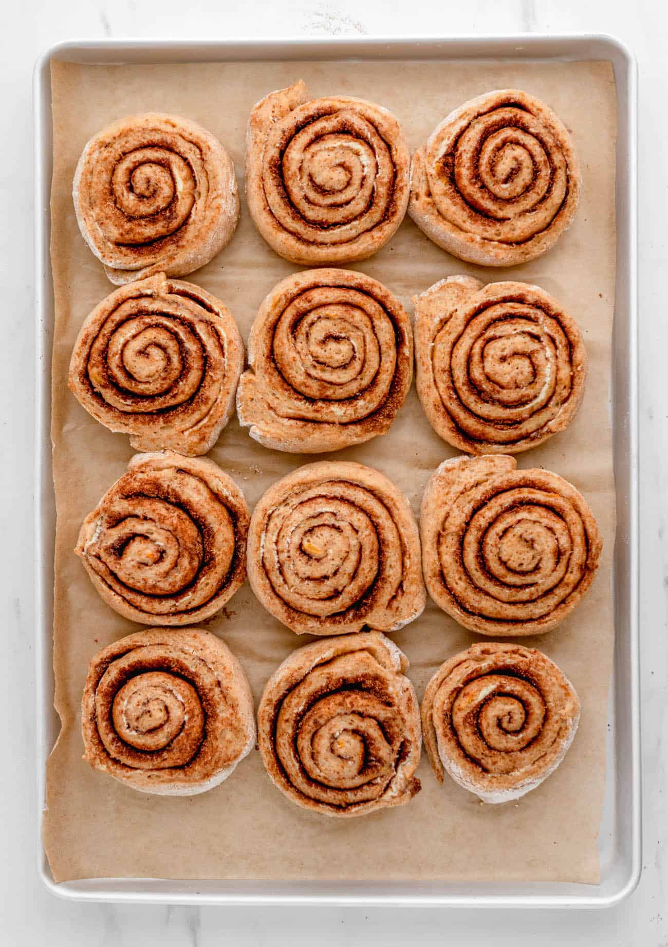 unbaked cut healthy cinnamon buns on a baking sheet