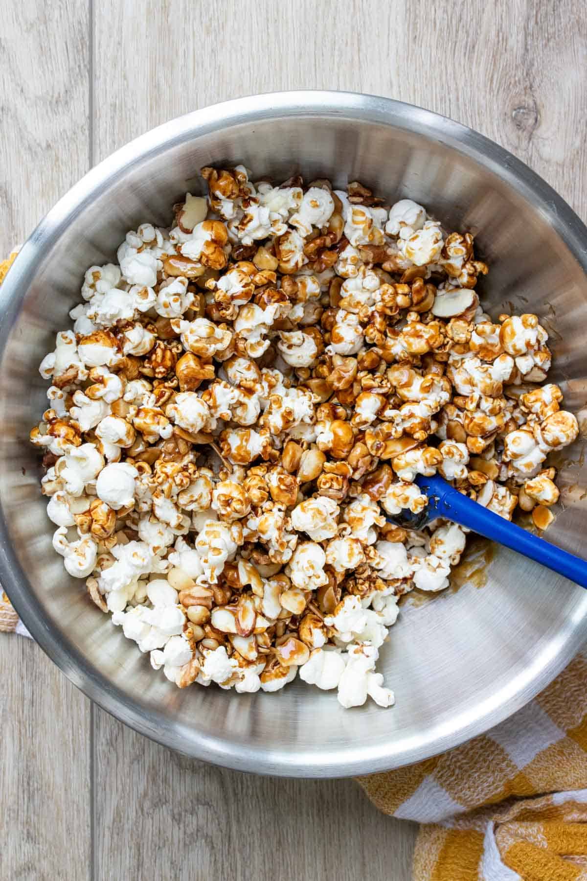 vegan caramel sauce poured on top of popcorn in a bowl