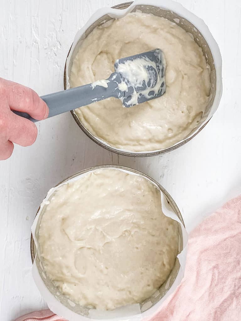 batter added to cake tins