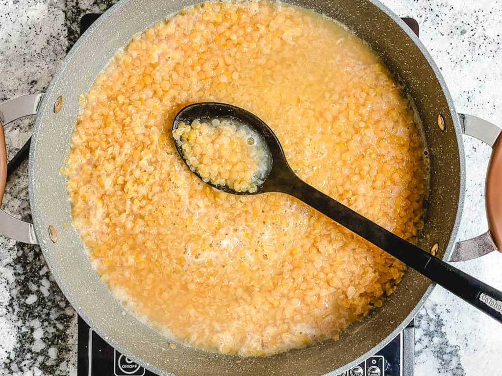masoor dal cooking in a large pot on the stove