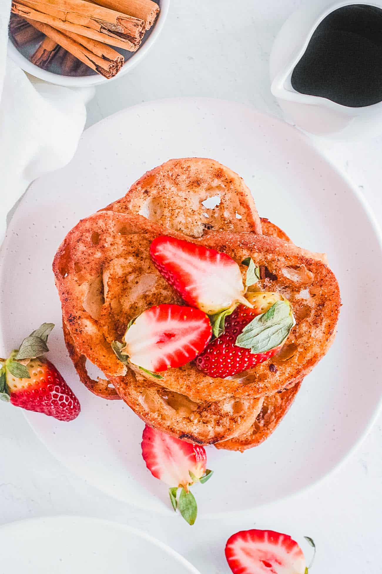 healthy easy dairy free vegan french toast recipe on a white plate with berries and powdered sugar
