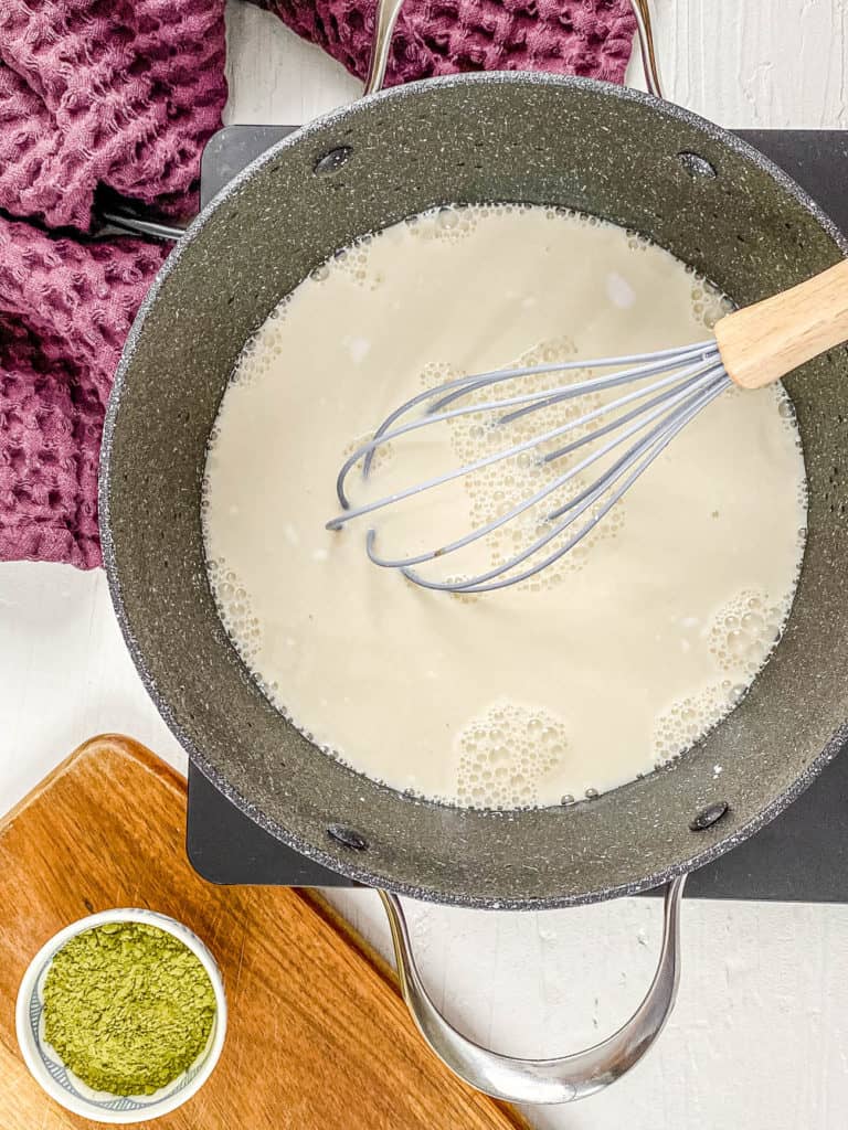 plant based milk and mix ins cooking in a pot