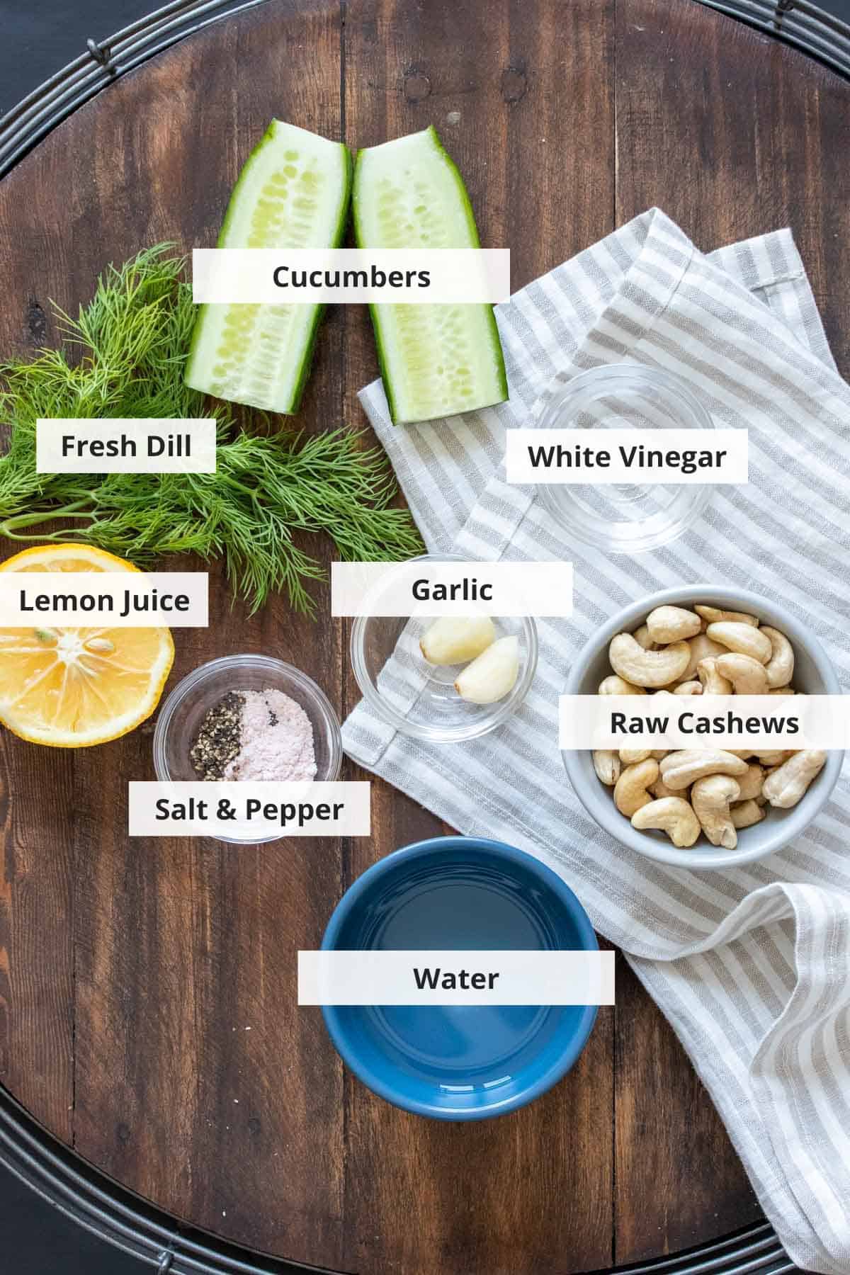 Ingredients for homemade vegan tzatziki sauce on a wood background.