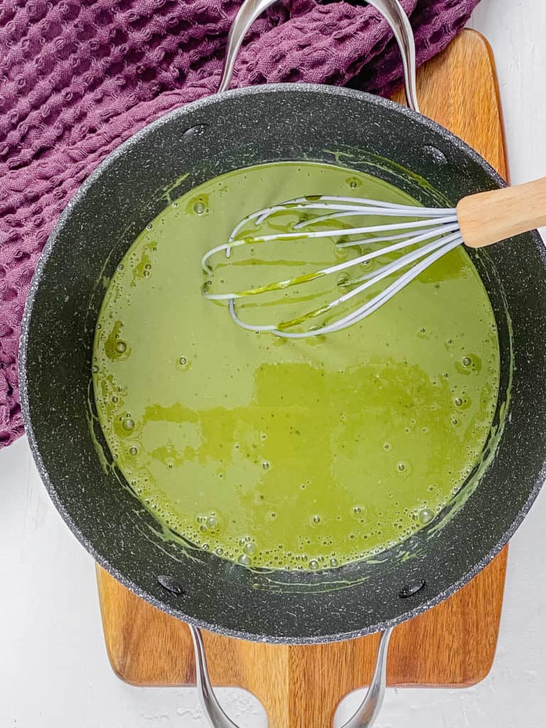 matcha and plant based milk and mix ins whisked in a pot