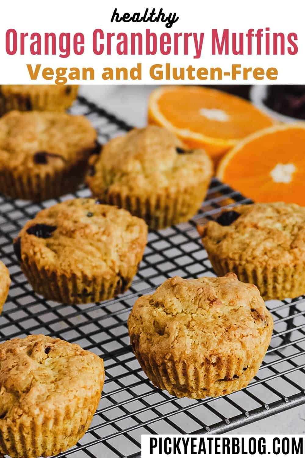 Orange cranberry muffins on cooling rack.