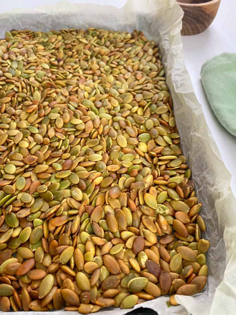 roasted pumpkin seeds on a baking sheet