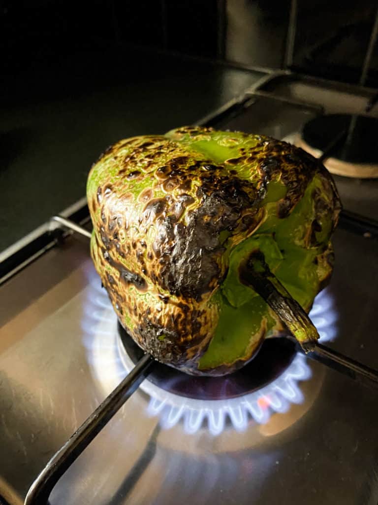 roasting a pepper on a stove