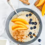 bowl of easy healthy jamaican cornmeal porridge recipe with fresh fruit and cinnamon