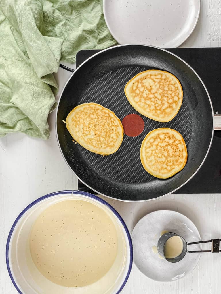 pancakes cooking in a skillet