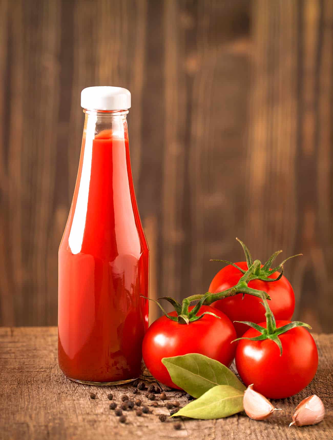 is ketchup vegan - Dark still life with ketchup and ingredients on the rough wood. Blurred background