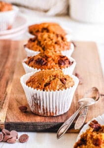 Easy peanut butter muffins with chocolate chips on a wooden cutting board.