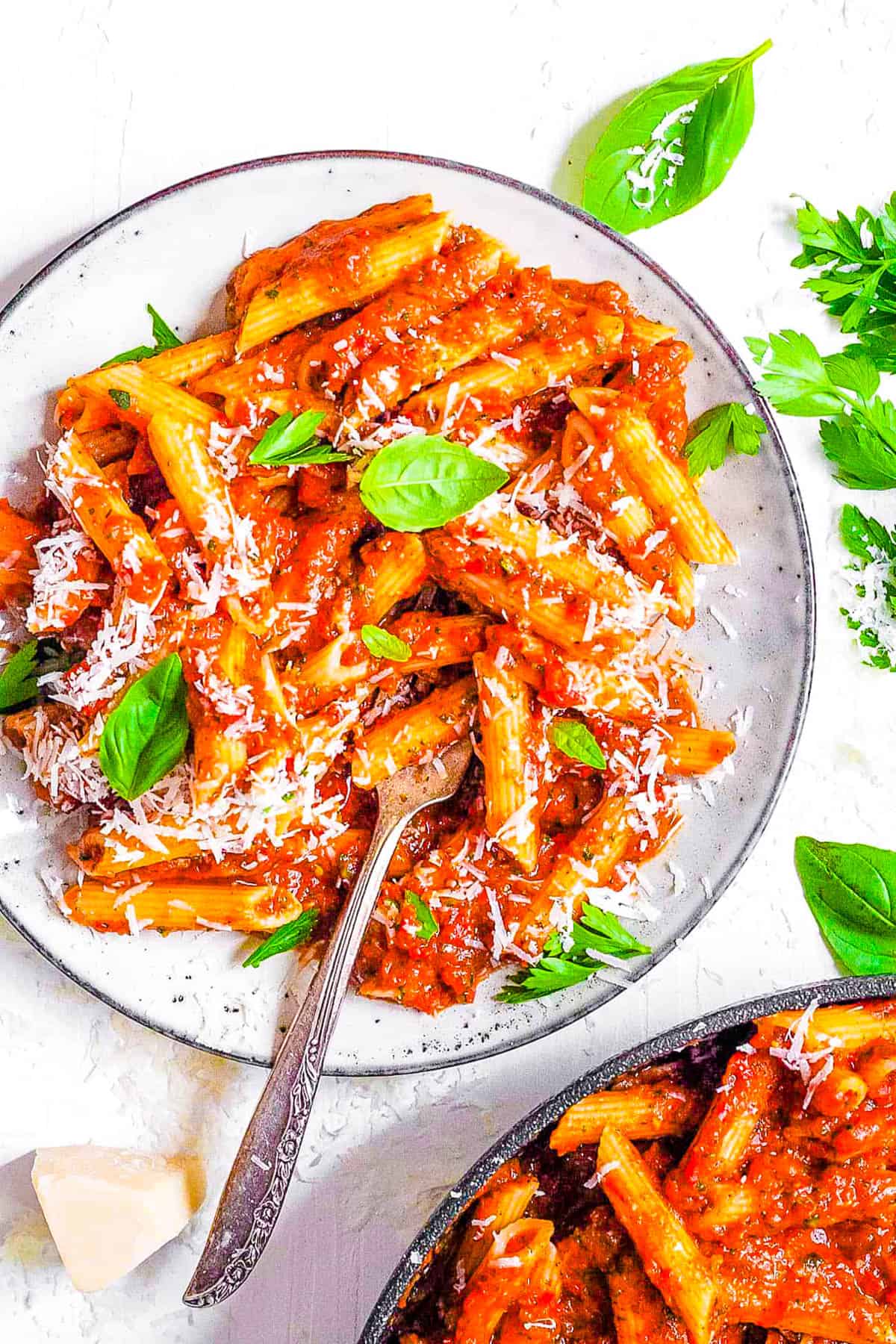 Red lentil pasta served on a white plate with superfood marinara sauce.