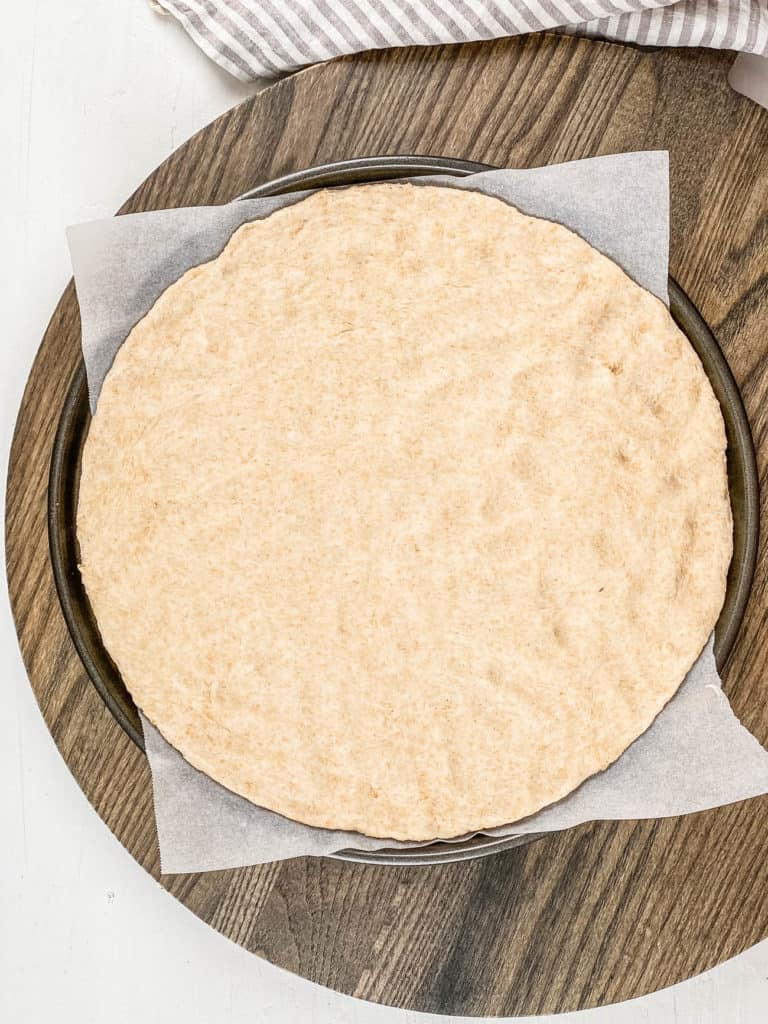 dough rolled out on a pizza pan