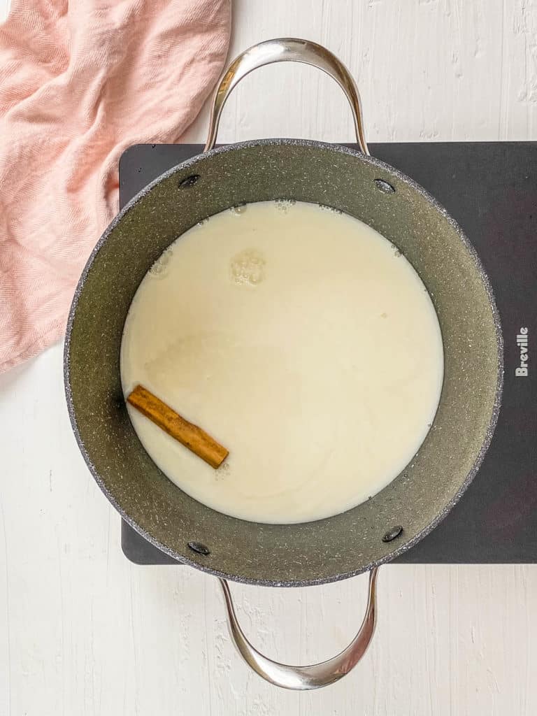 soy milk and cinnamon cooking in a pot