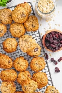 Healthy sugar free oatmeal cookies with raisins stacked on a wire rack.