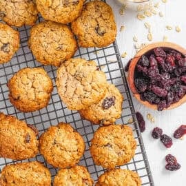 Healthy sugar free oatmeal cookies with raisins stacked on a wire rack.