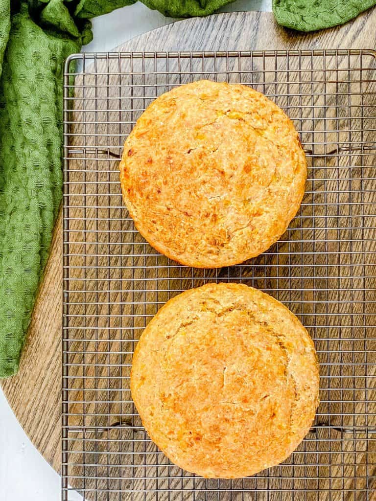 Two baked loaves of healthy smash cake on a wire cooling rack.