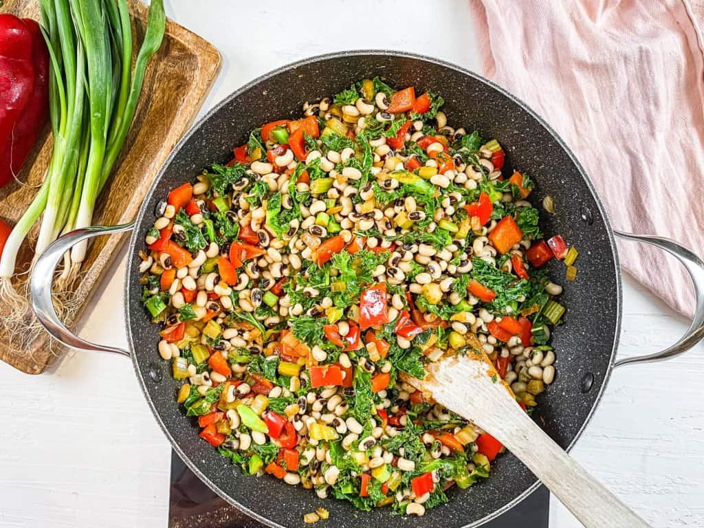 kale, veggies, rice and black eyed peas added to pot