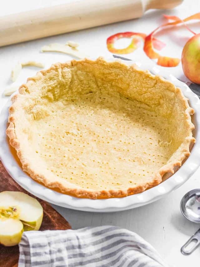 A baked gluten-free pie crust in a pie pan.