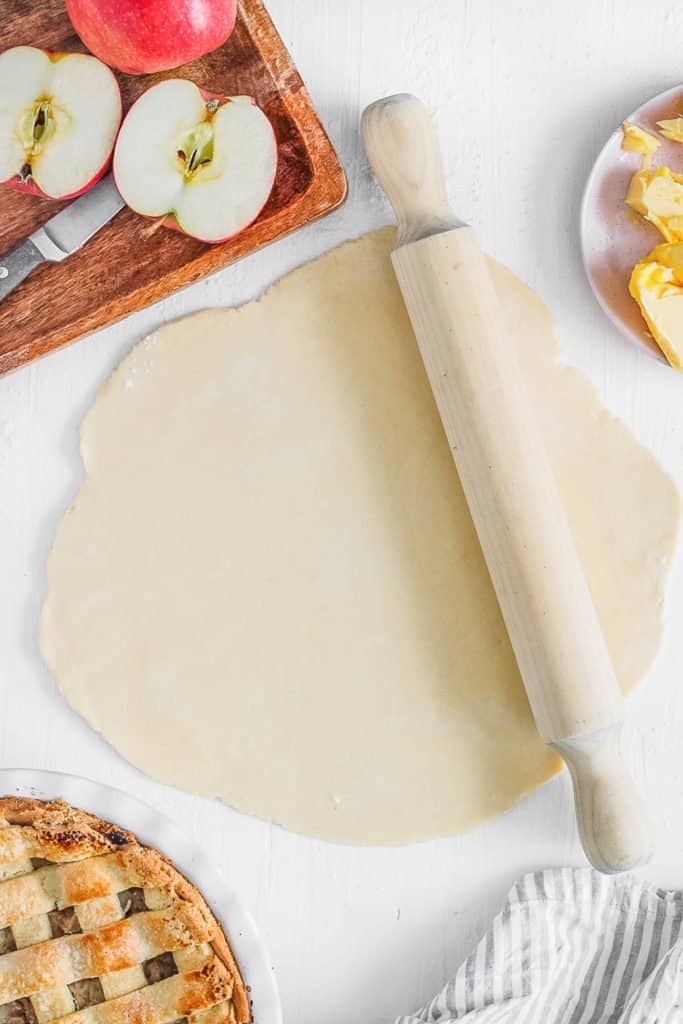 raw dough rolled out on a cutting board