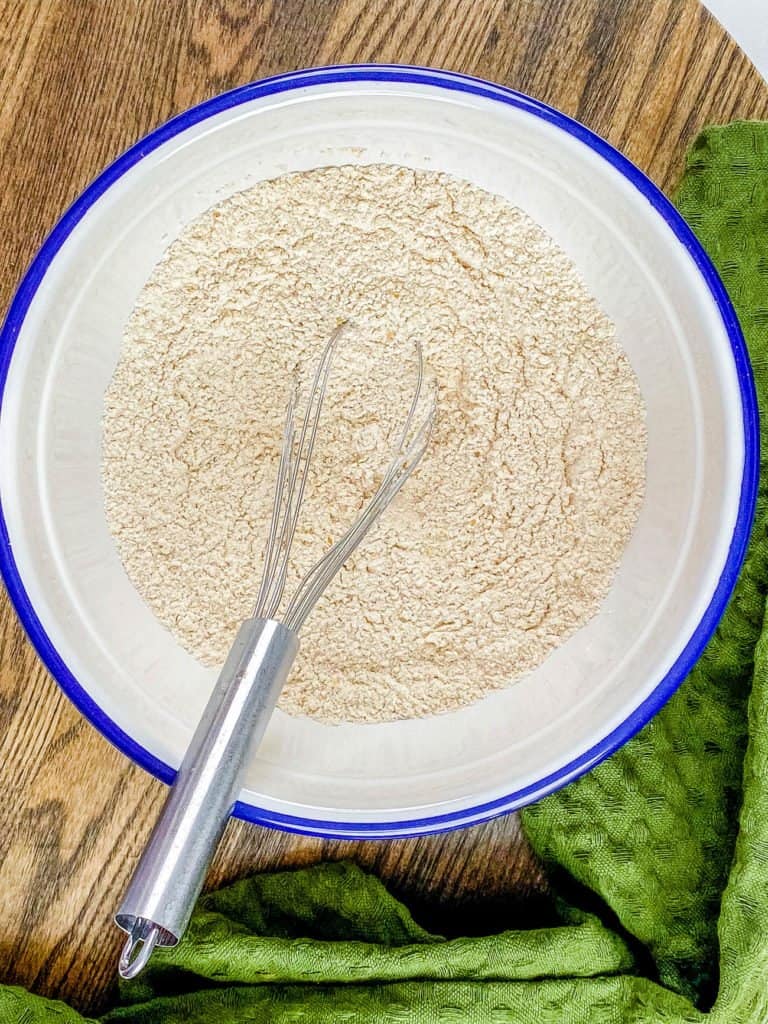Whisking the dry ingredients together in a bowl.