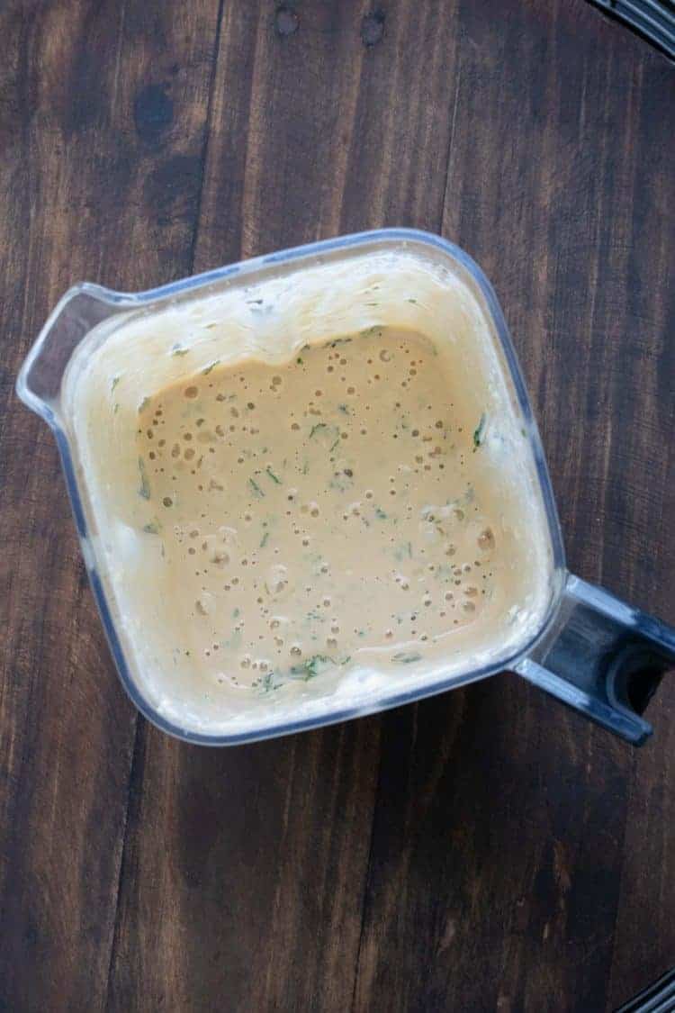 Top view of creamy peach mixture in a blender