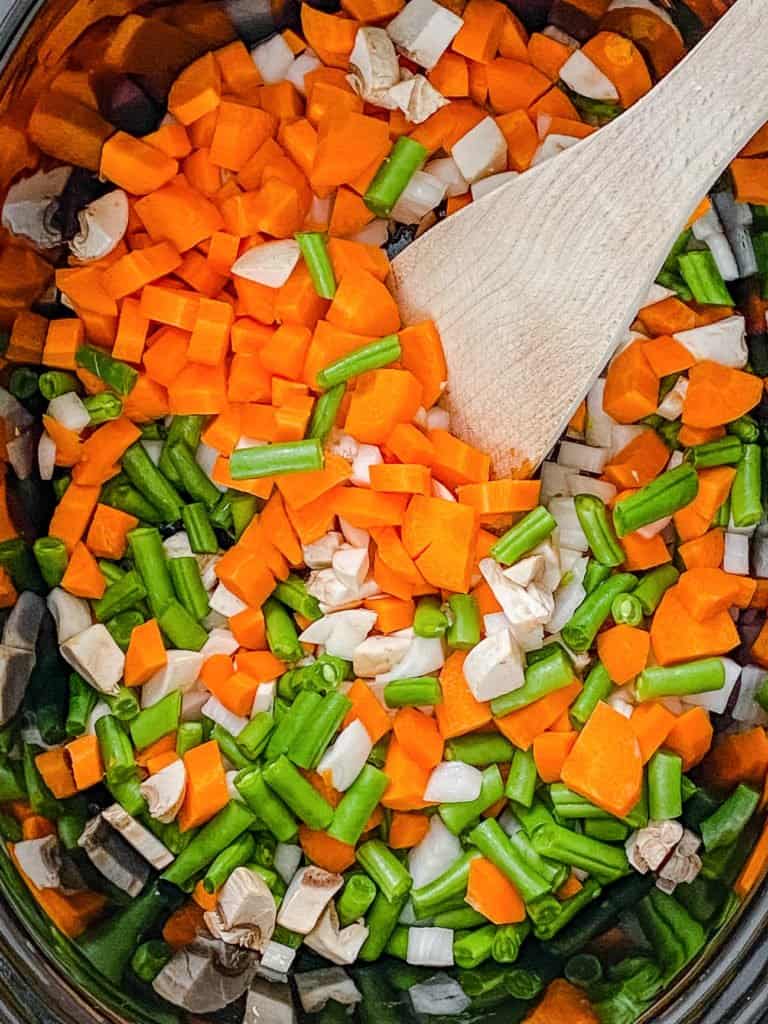 carrots and green beans cooking in a pot