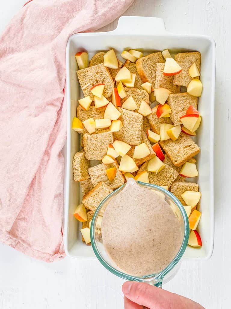 Pouring the flax and milk custard over the bread and apples.