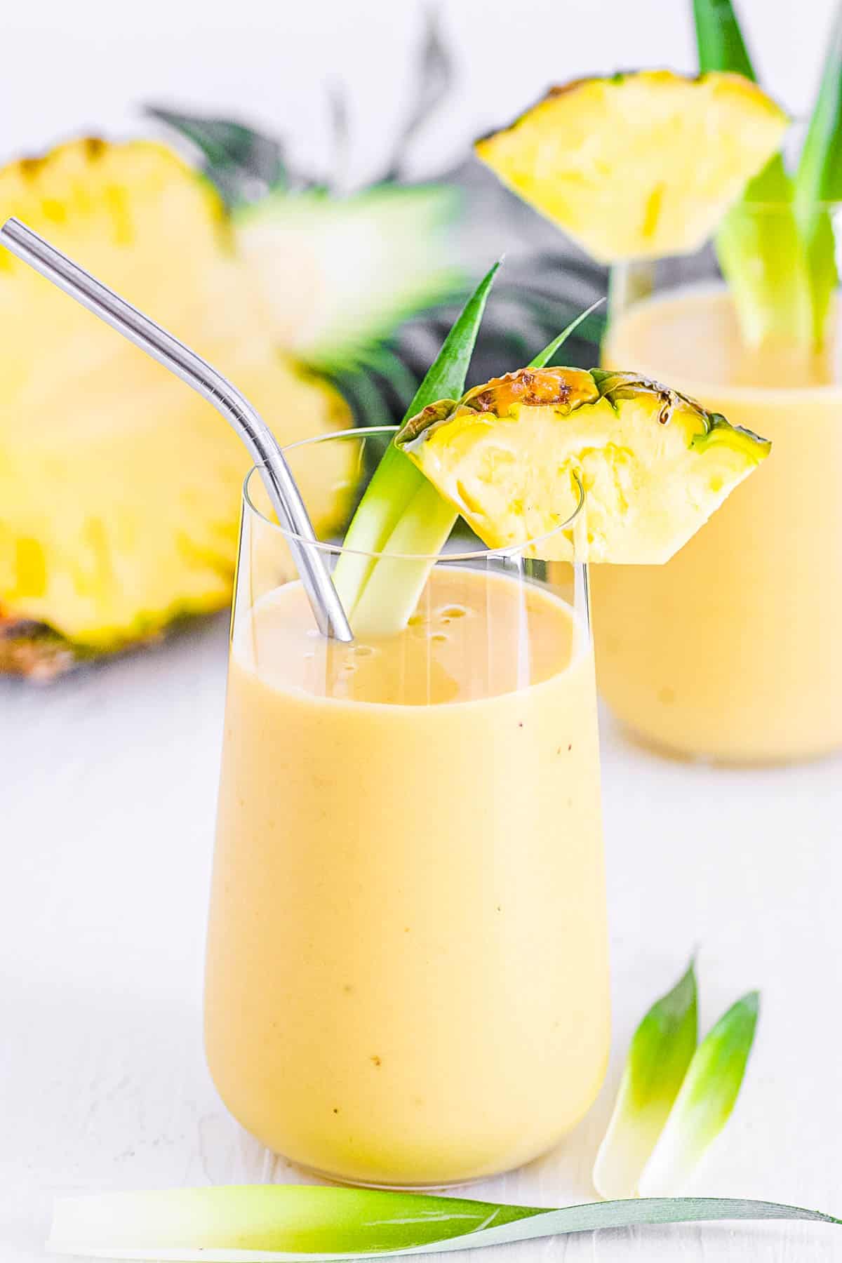 easy healthy vegan mango pineapple banana smoothie recipe in a gl،