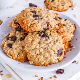 easy healthy vegan oatmeal chocolate chip cookies recipe stacked on a white plate