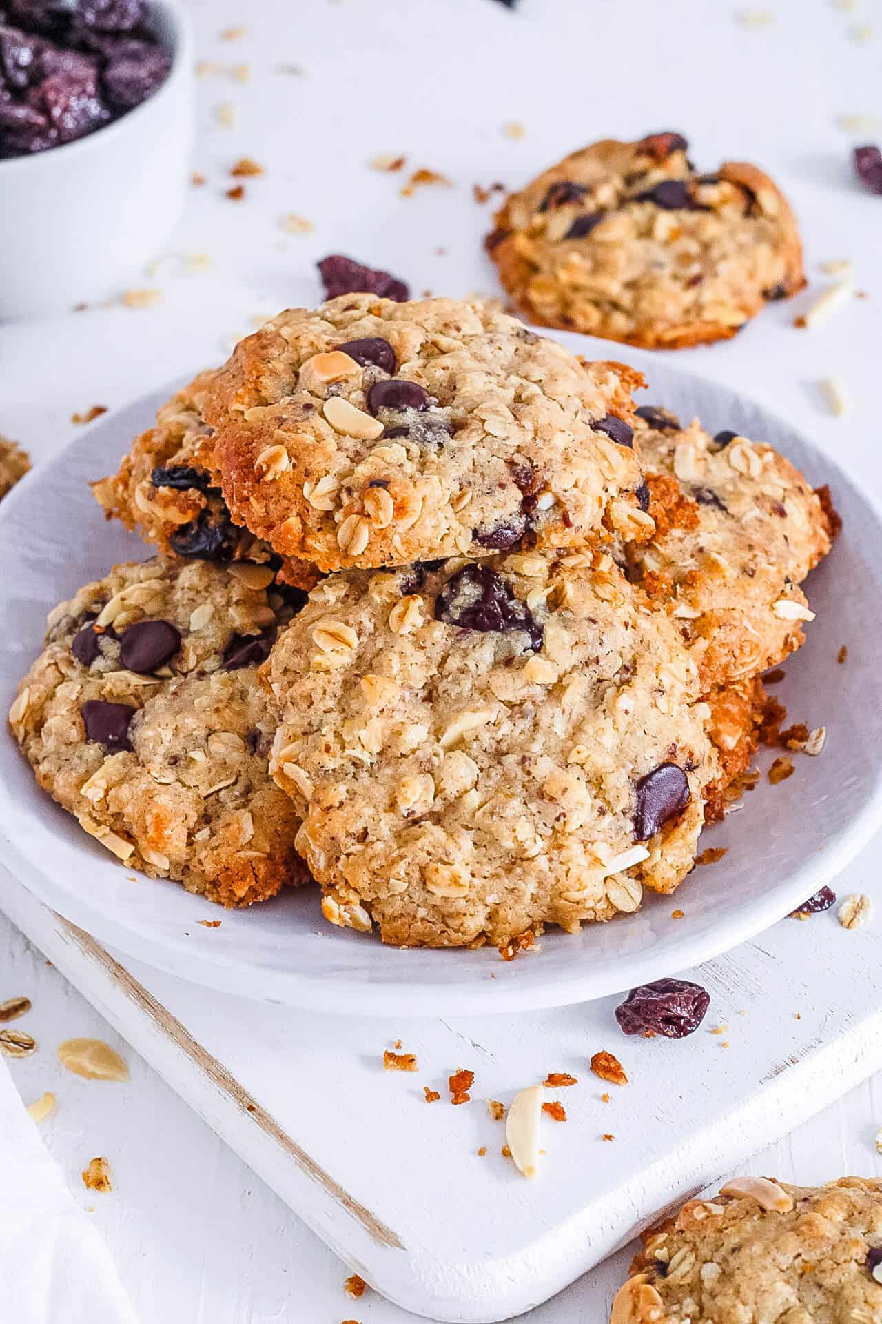 Vegan oatmeal chocolate chip cookies recipe stacked on a white plate.