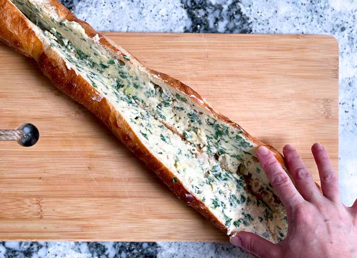 Garlic and parsley butter spread on inside of baguette.