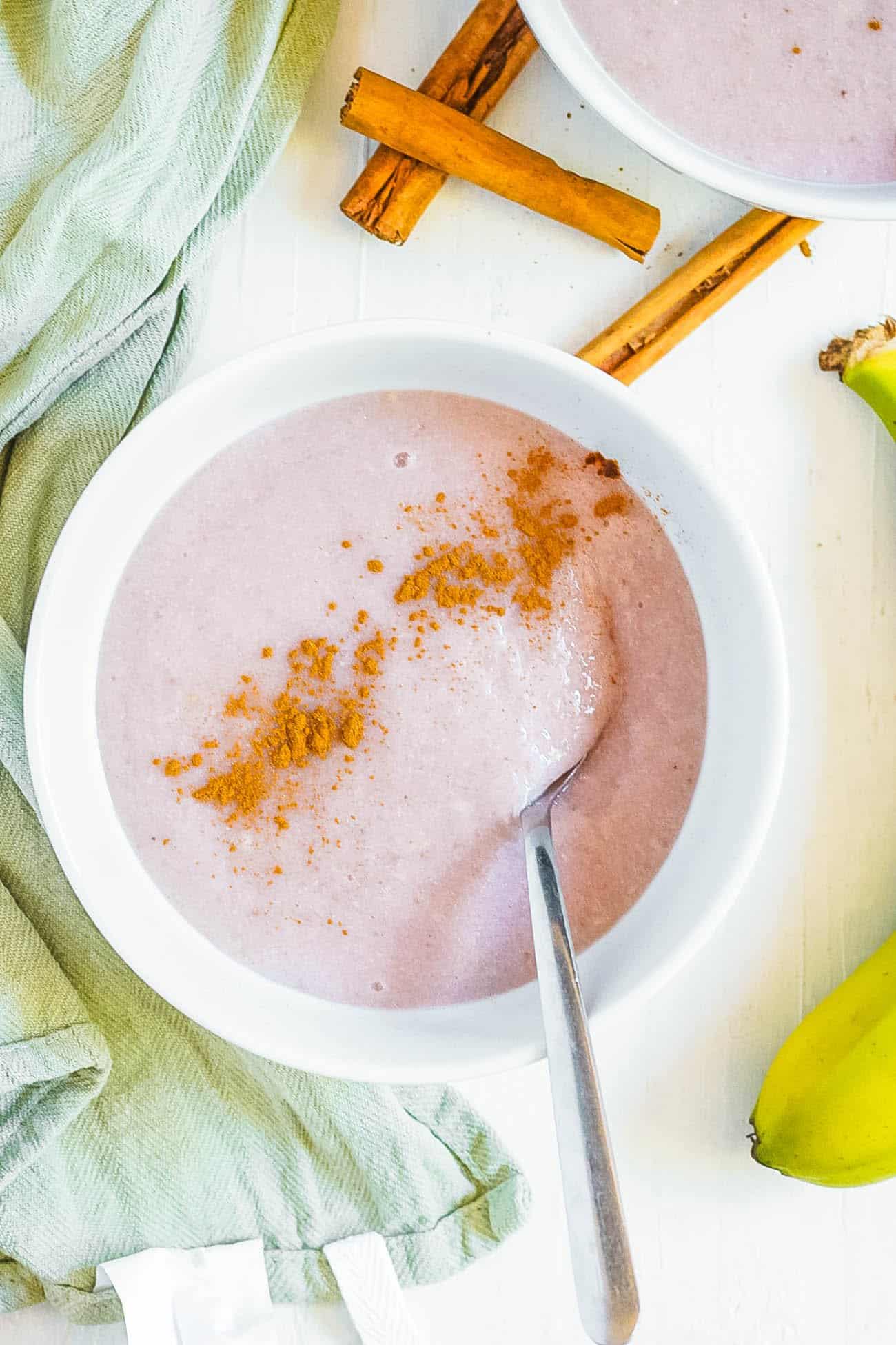 healthy easy vegan gluten free jamaican banana porridge recipe with cinnamon in a white bowl
