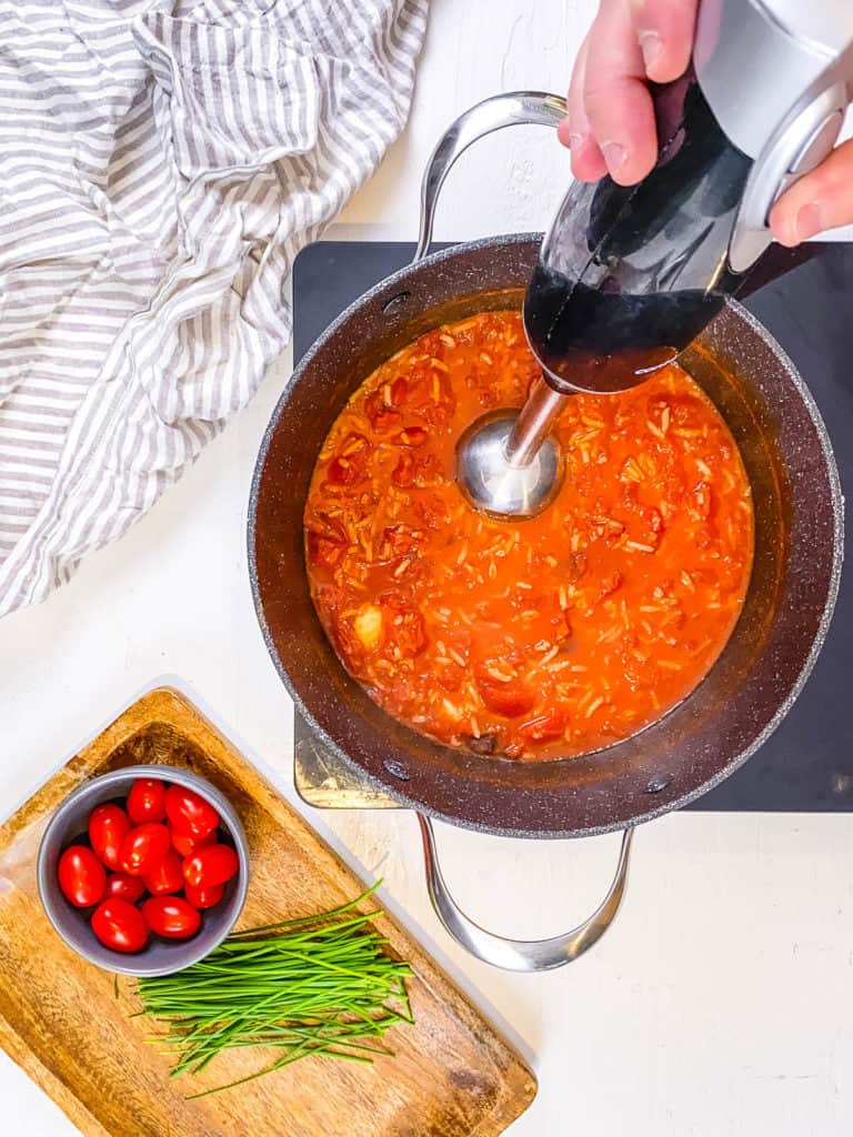 immersion blender blending soup in a pot