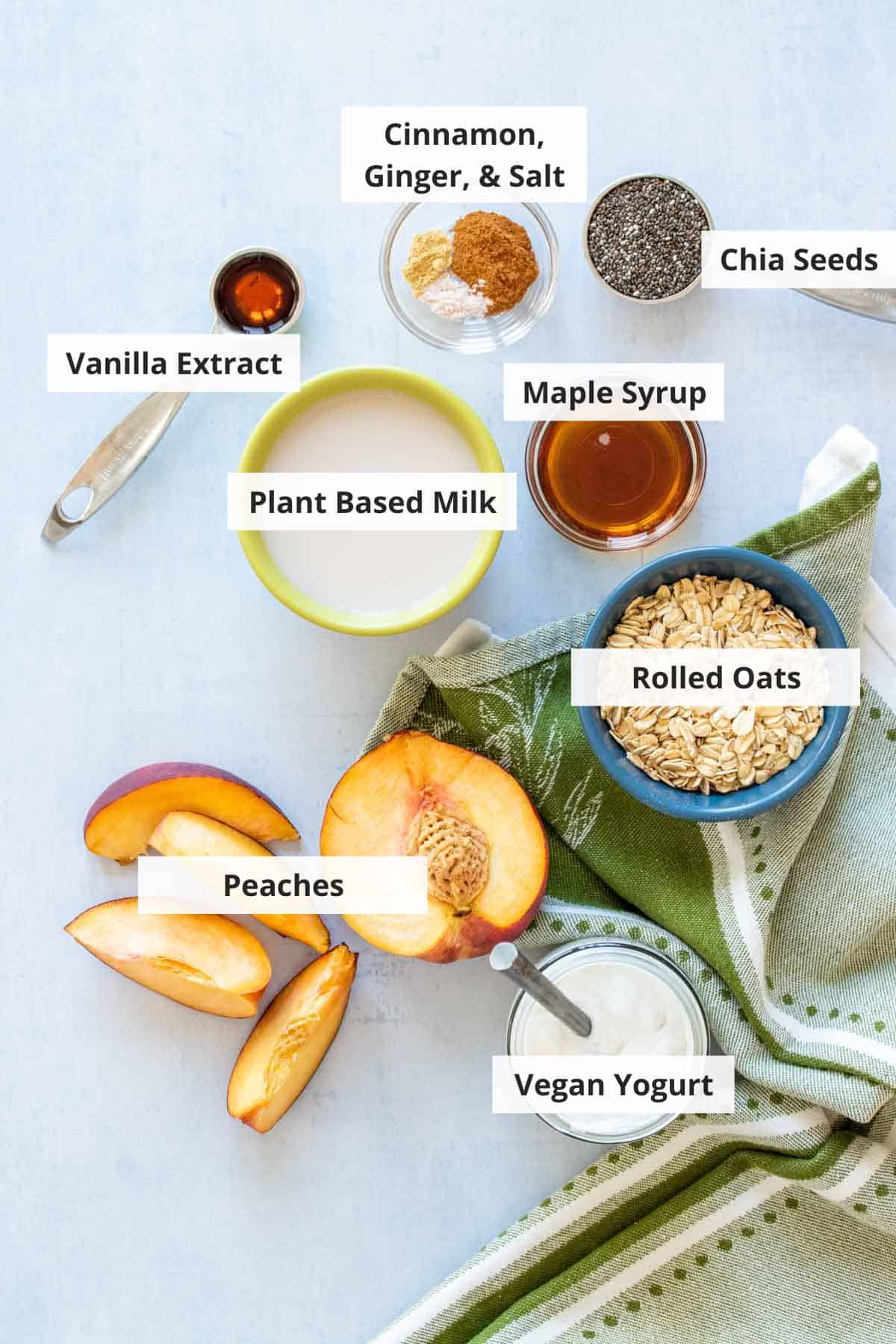 Ingredients for peach overnight oats on a white countertop.