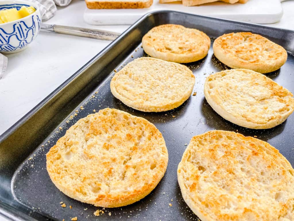 toasted english muffins on baking sheet