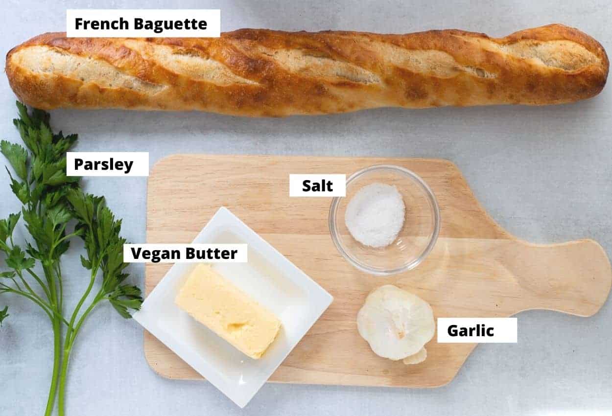 Ingredients for Vegan Garlic Bread: Parsley, baguette, vegan butter, salt, garlic head.