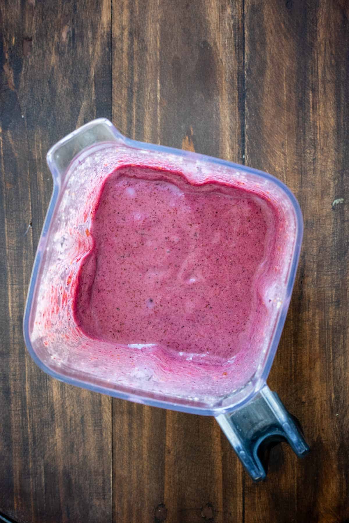 Top view of a blender with a purple smoothie inside
